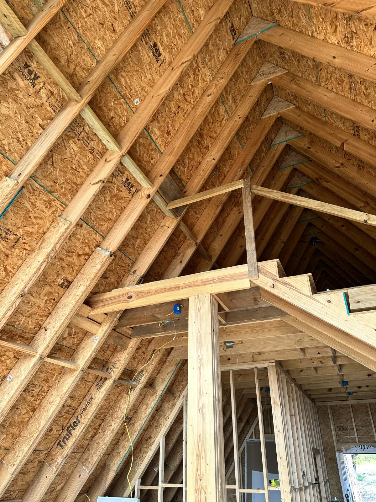 Interior view of the A-frame roof rafters meeting at the ridge.